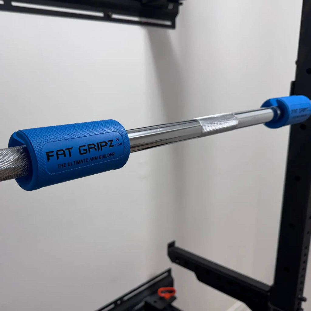 Fat Gripz Pro Series pair fitted on a barbell in a squat rack