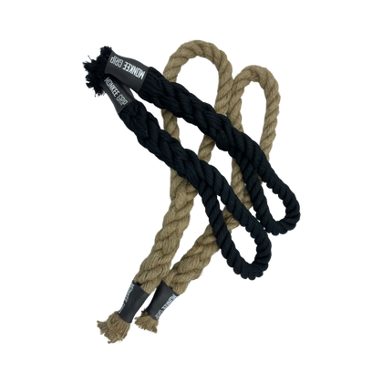 Pair of Monkee Grip Rope Grips, one black and one natural color, designed for enhancing grip strength, hanging on a gym bar.