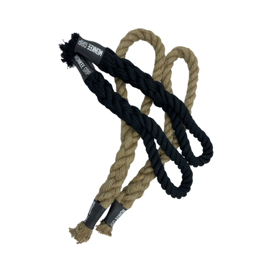Pair of Monkee Grip Rope Grips, one black and one natural color, designed for enhancing grip strength, hanging on a gym bar.