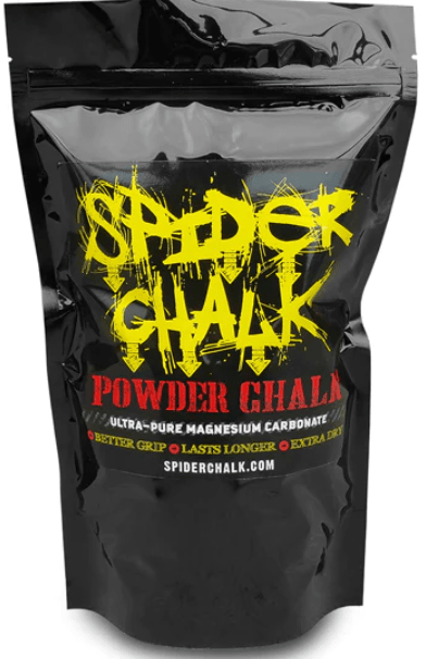 When muscular hand lifts a heavy weight. Spider chalk coats the hand.