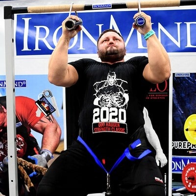 An athlete strains to lift his body in a pull-up with two IronMind® Rolling Thunder® Revolving Deadlift Handles.